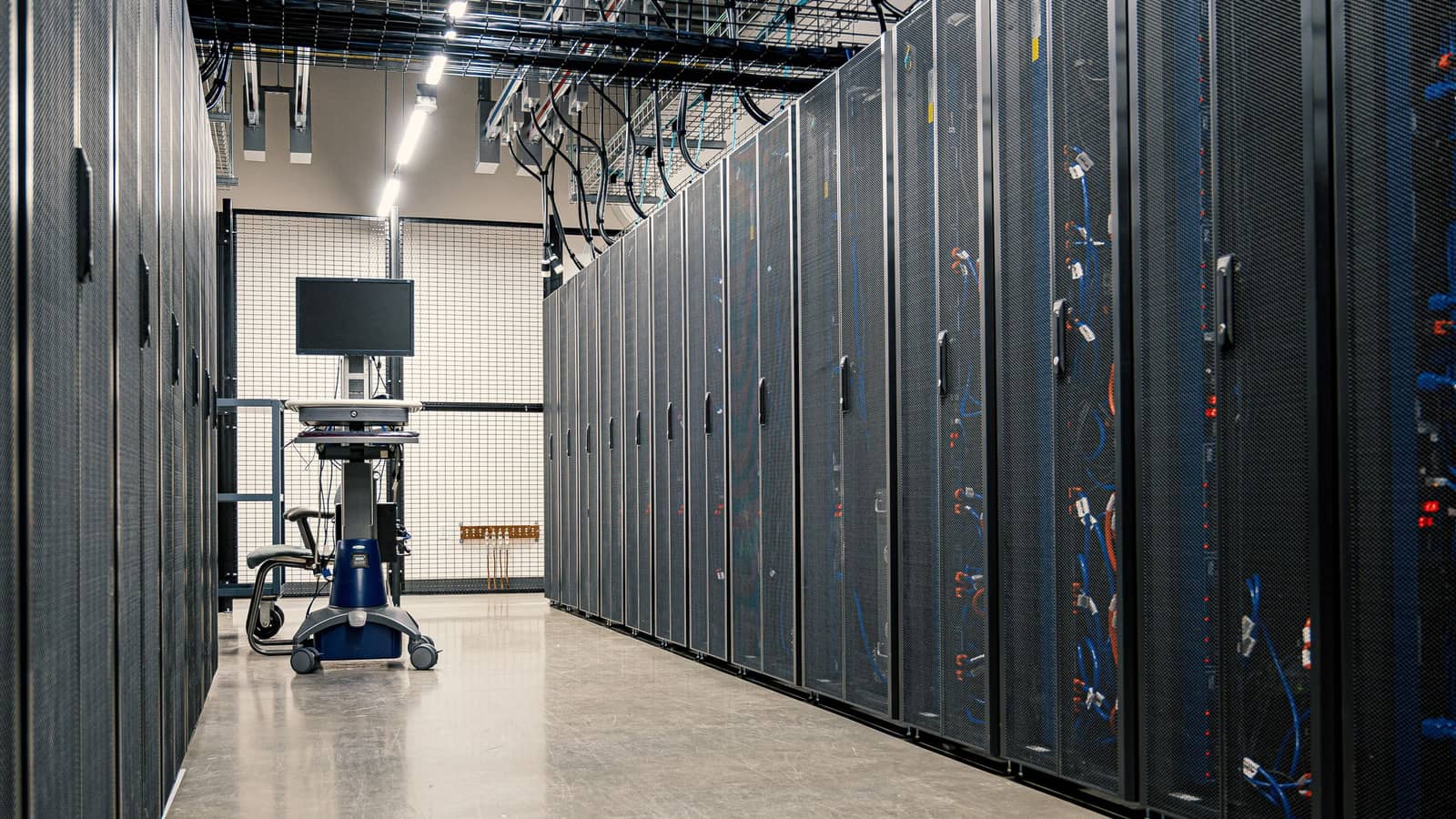 A corridor of server racks in a data centre