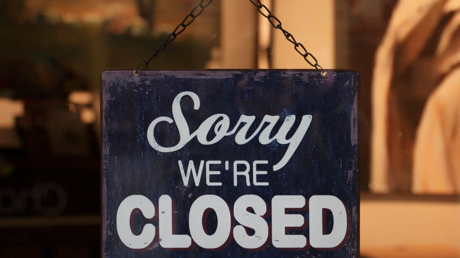 A sign on a shop door reading Sorry We Are Closed