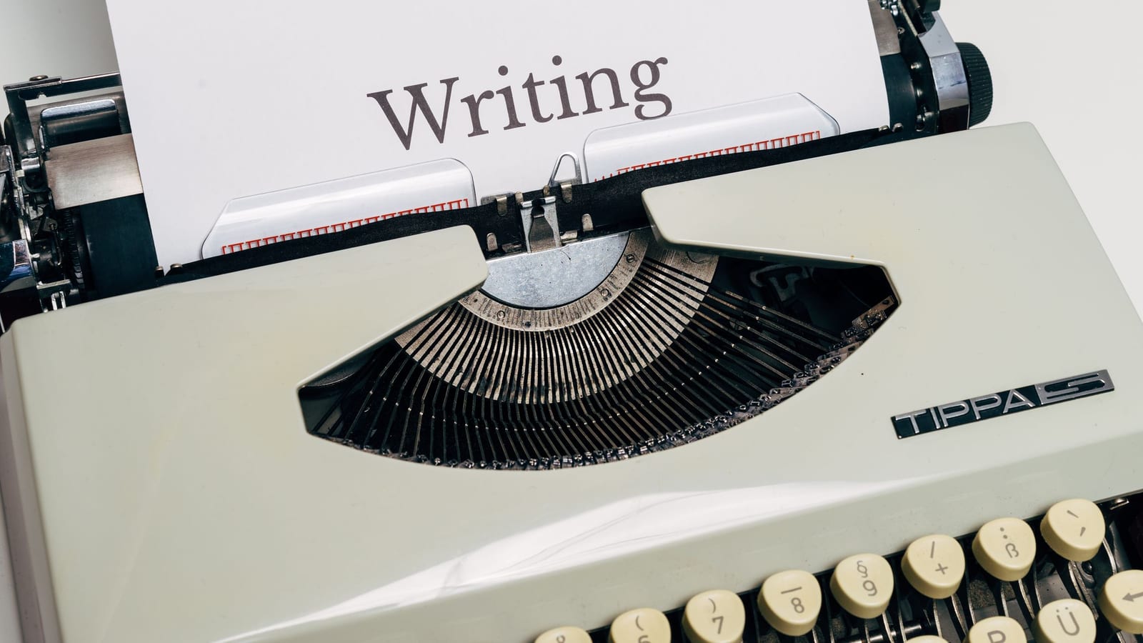 A vintage typewriter with the word Writing typed on the page