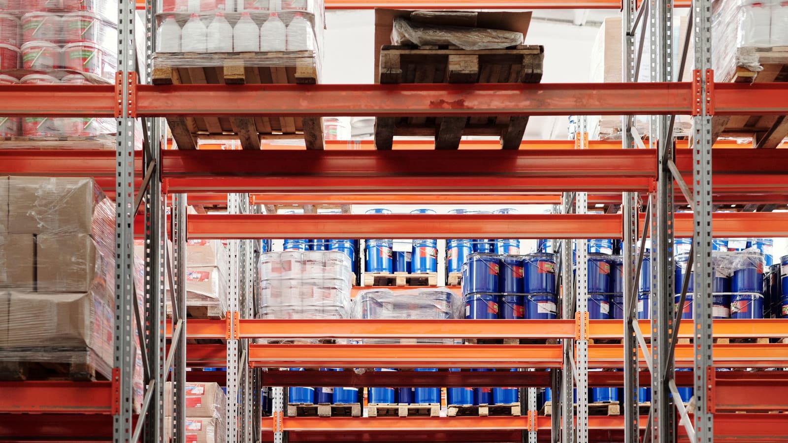 Warehouse shelving stacked with pallets of stock