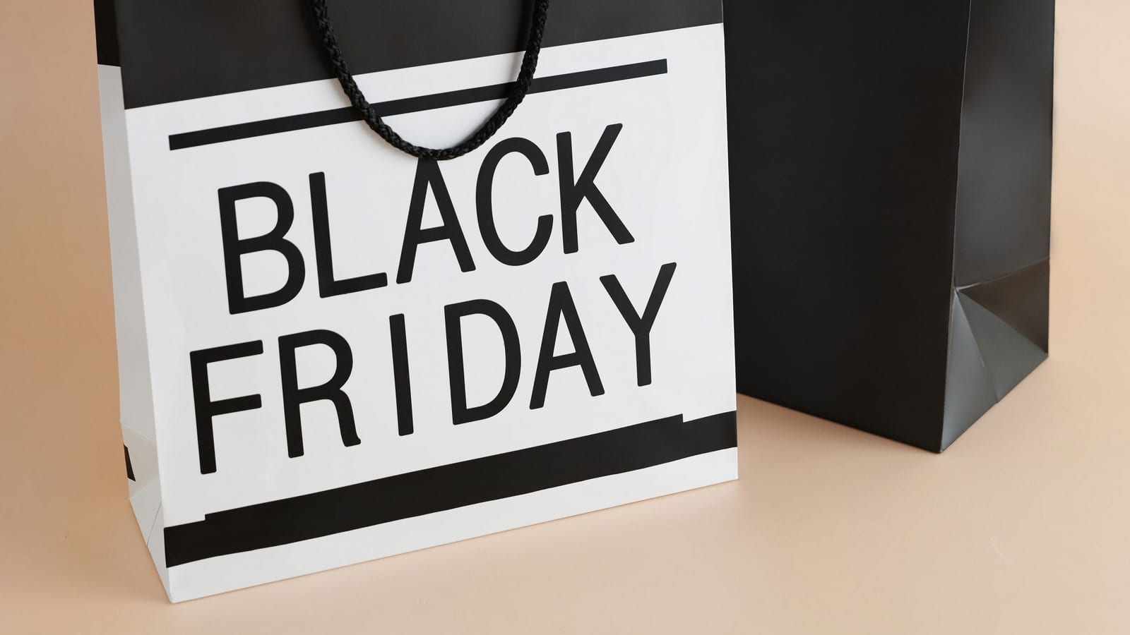 Two paper shopping bags printed with Black Friday
