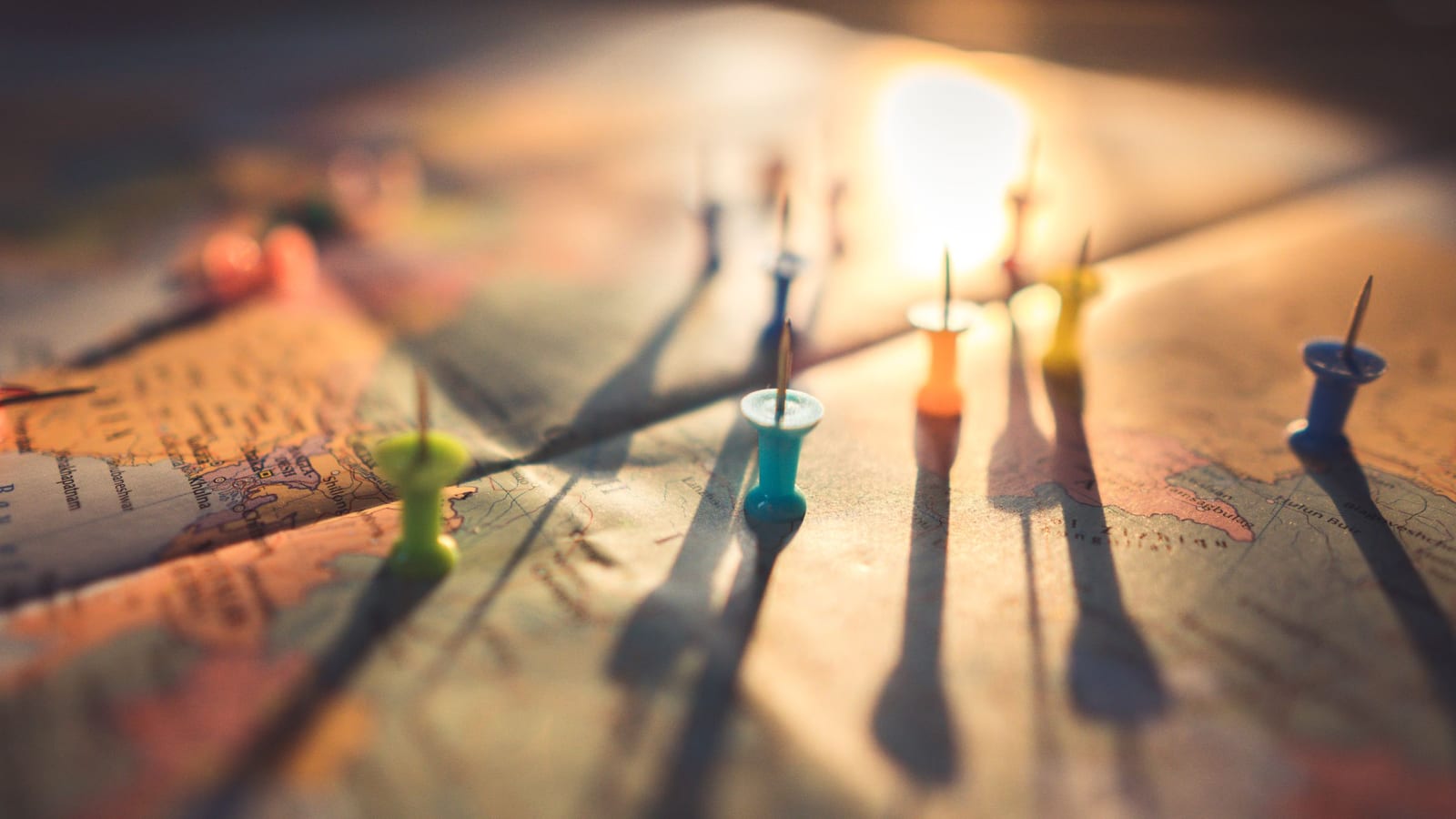 Coloured push pins on a world map