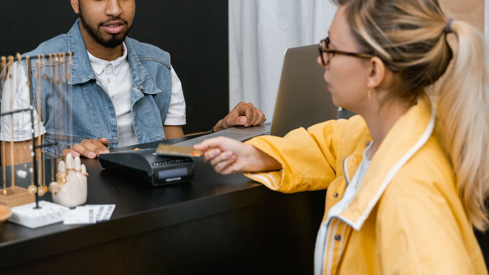 A customer paying by card at a boutique counter