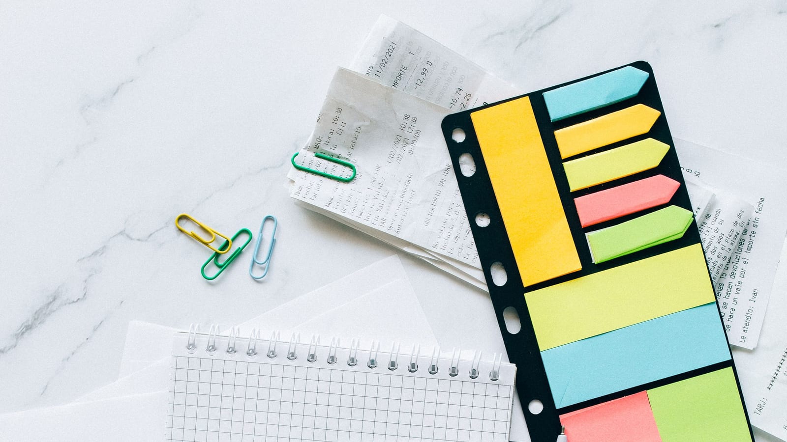 Tax paperwork, a calculator, and sticky notes on a desk